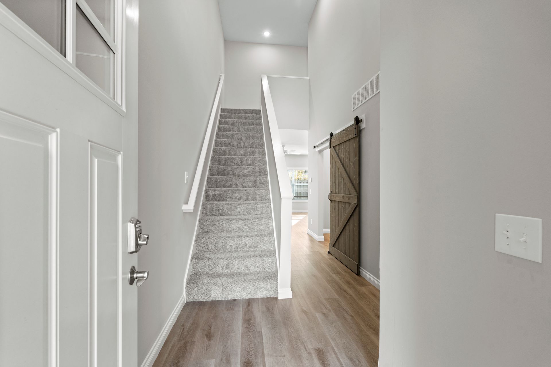 Photo of the front entrance and showing a landing to a staircase