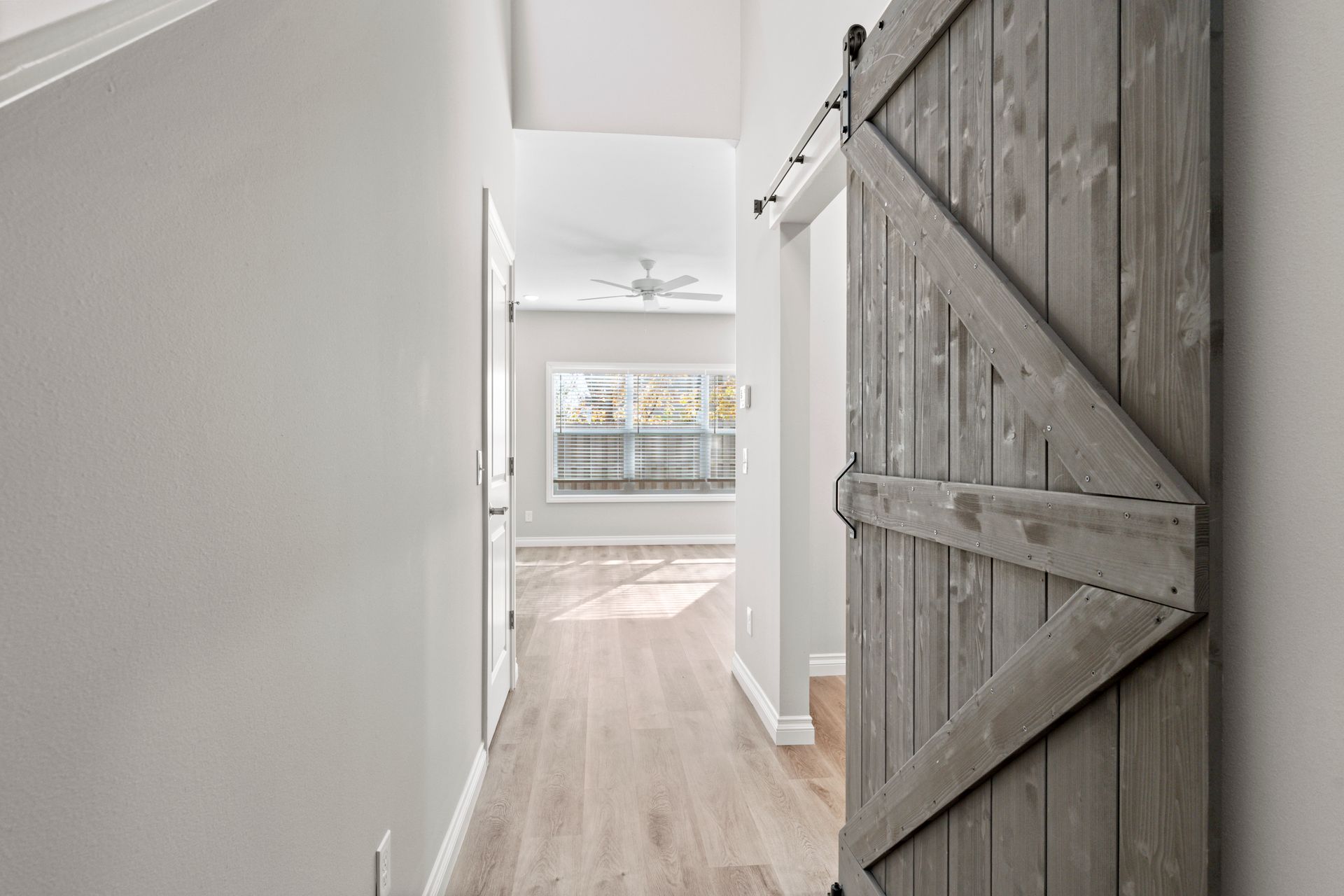 Photo of an open, wooden door leading into a room