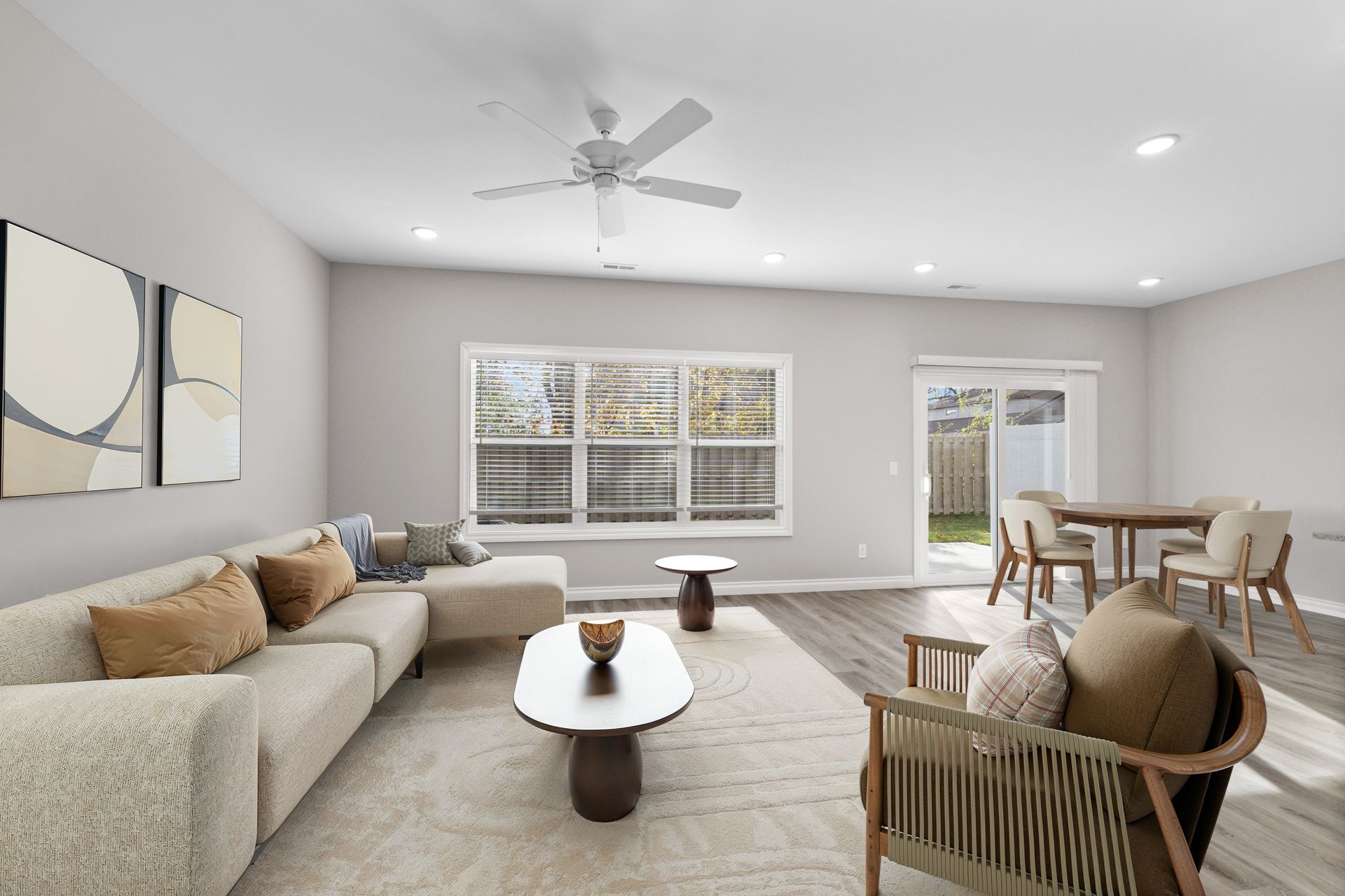 Photo of a living room with a wide couch and some other earth-tone furniture