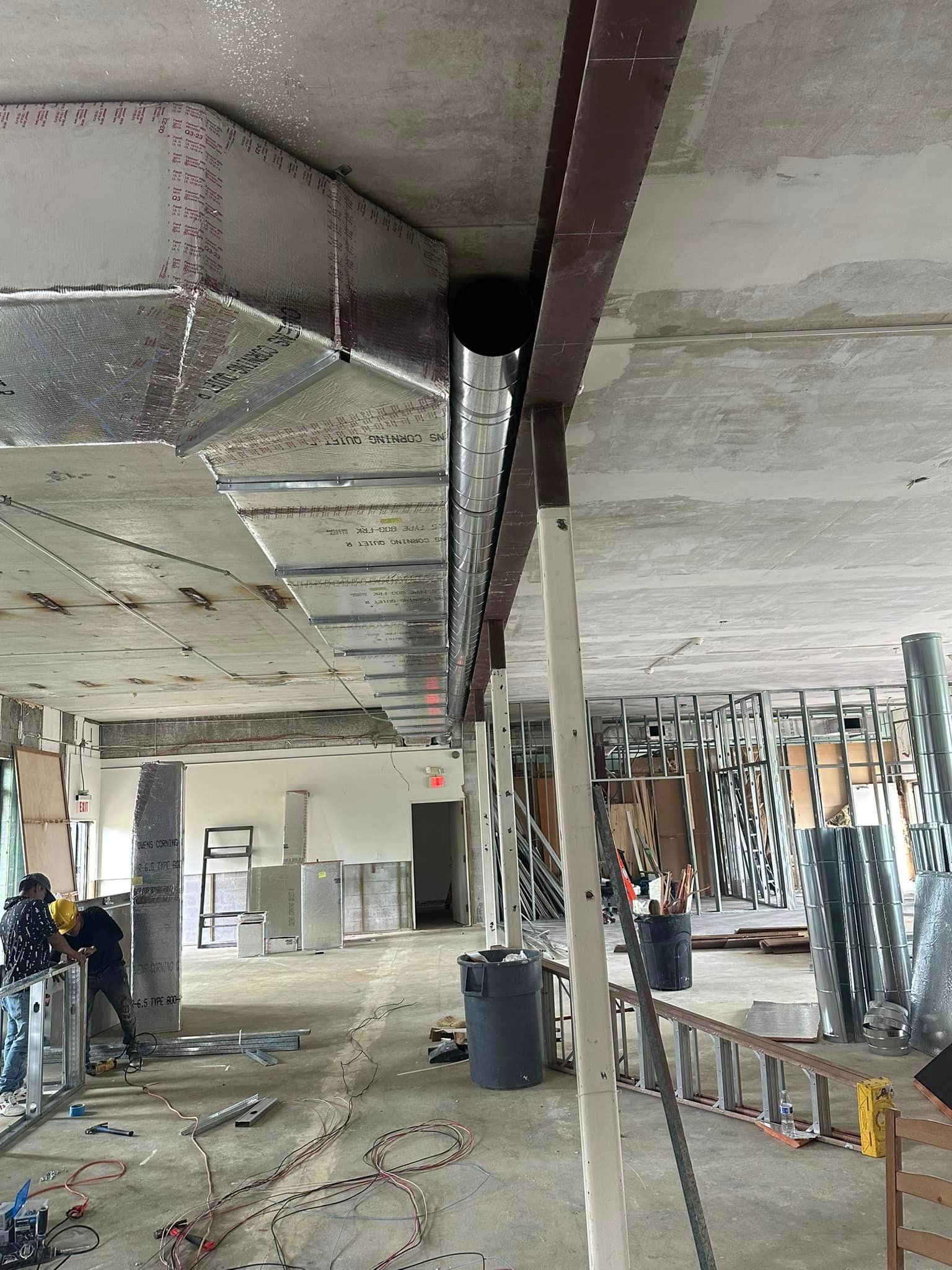 A large room with a lot of pipes hanging from the ceiling