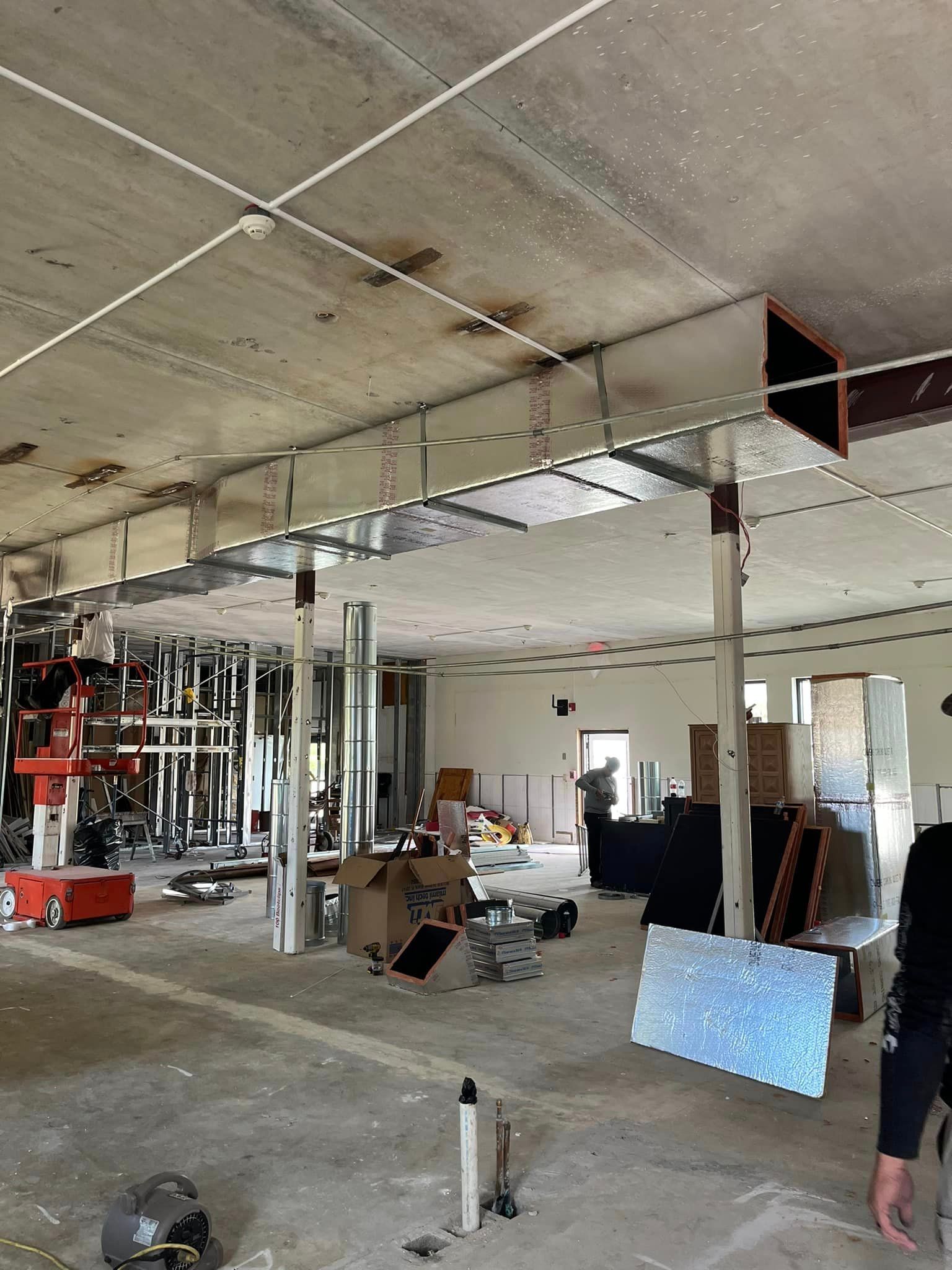 A large room with a ceiling that is being remodeled.