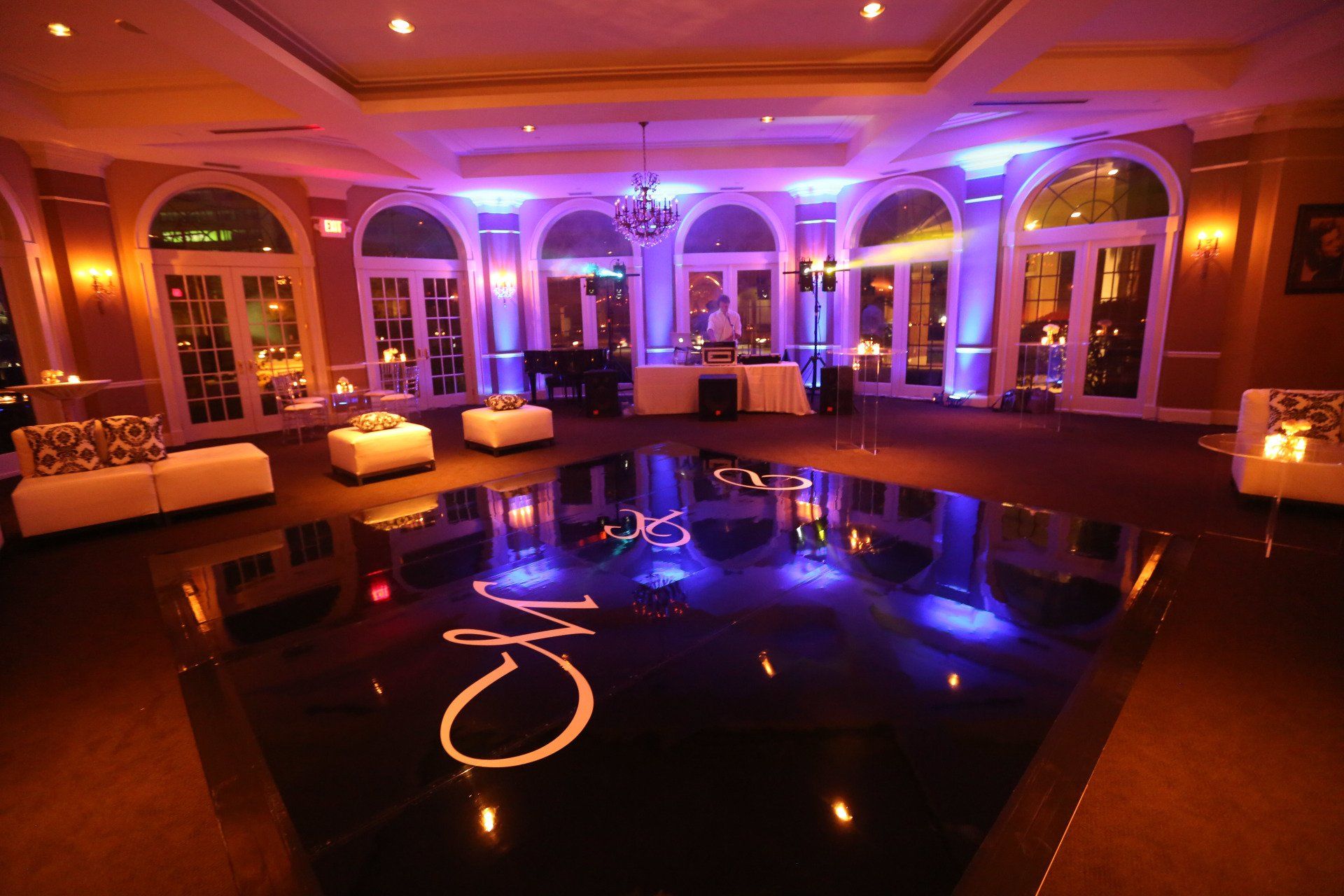 A large room with a dance floor and a monogram on it