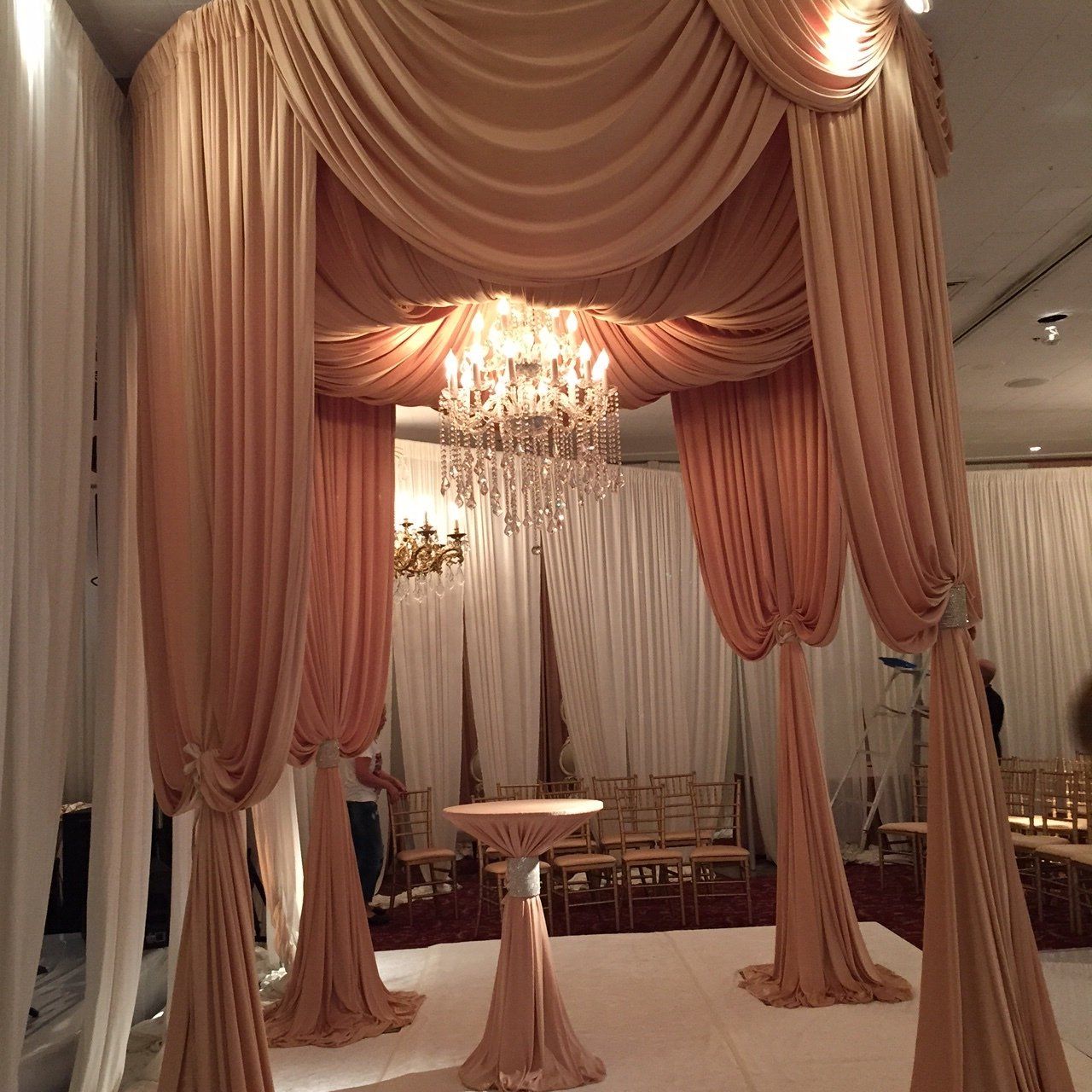 A canopy with a chandelier hanging from the ceiling