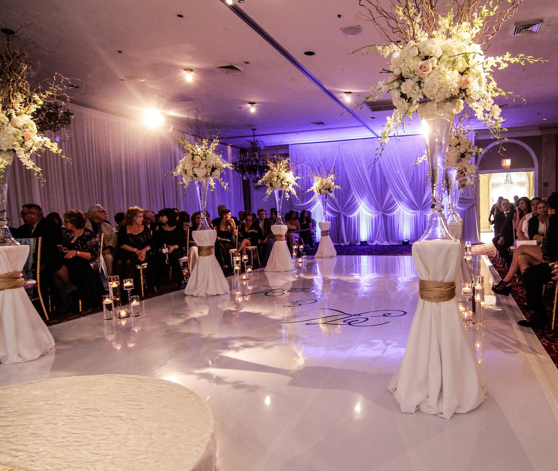 A wedding ceremony is taking place in a large room