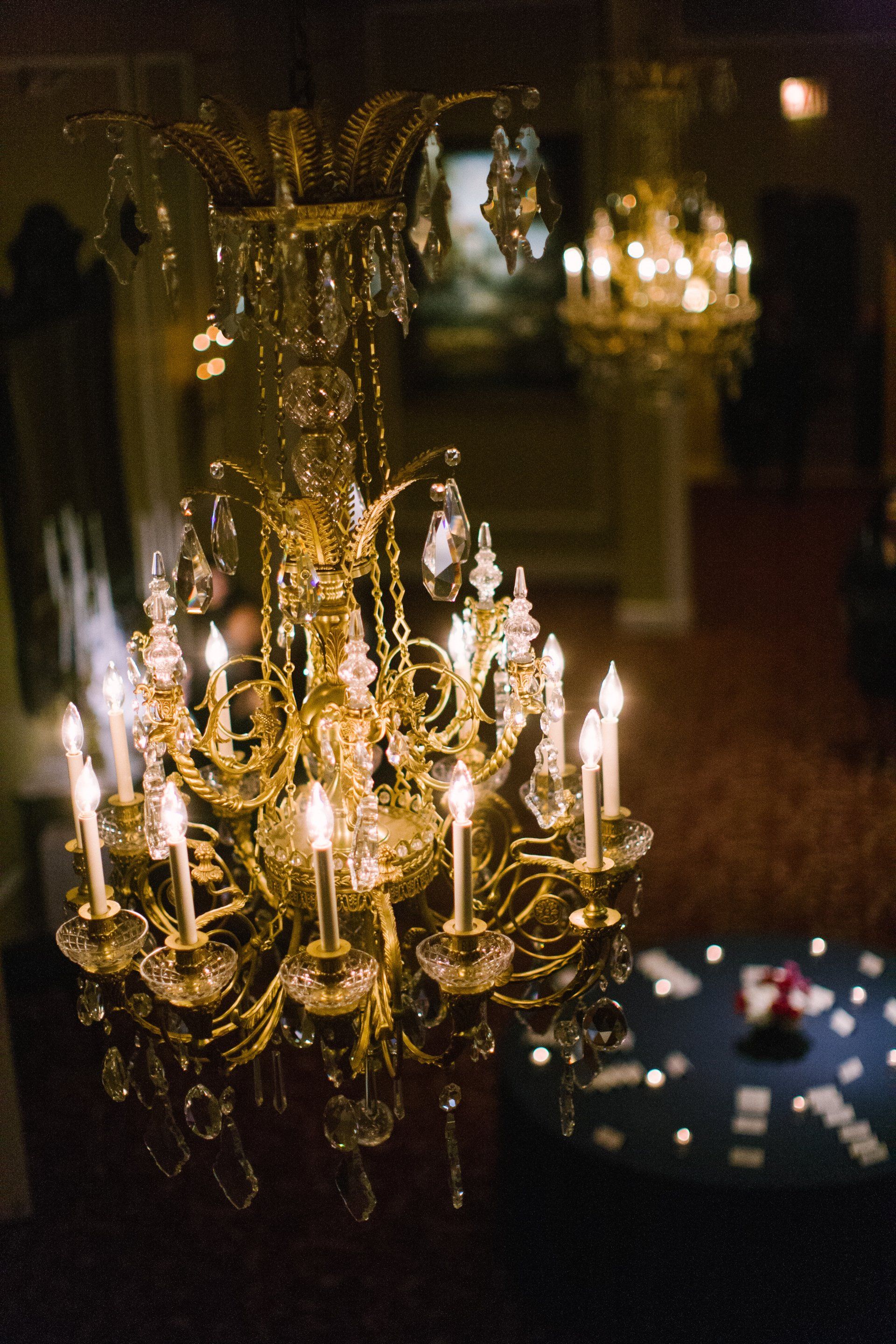 A chandelier is lit up in a dark room