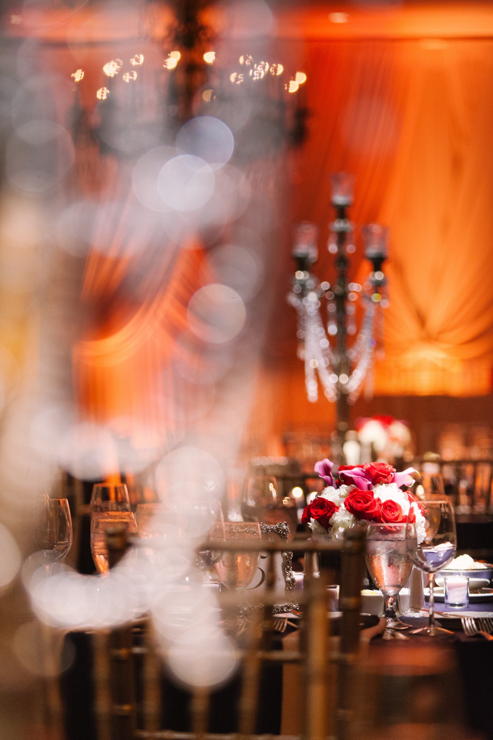 A blurry picture of a table set for a wedding reception.