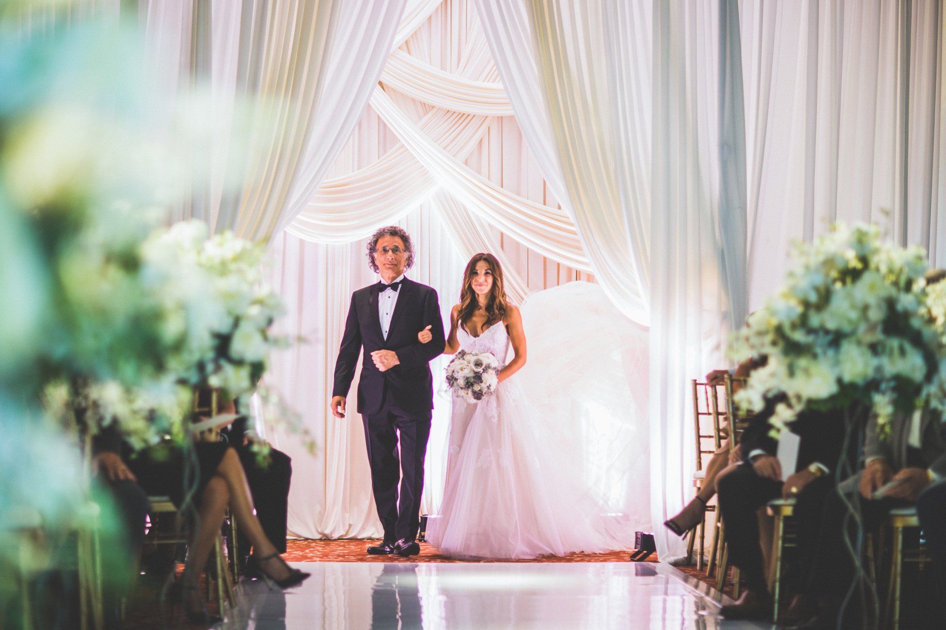 A bride and groom are walking down the aisle at their wedding ceremony.