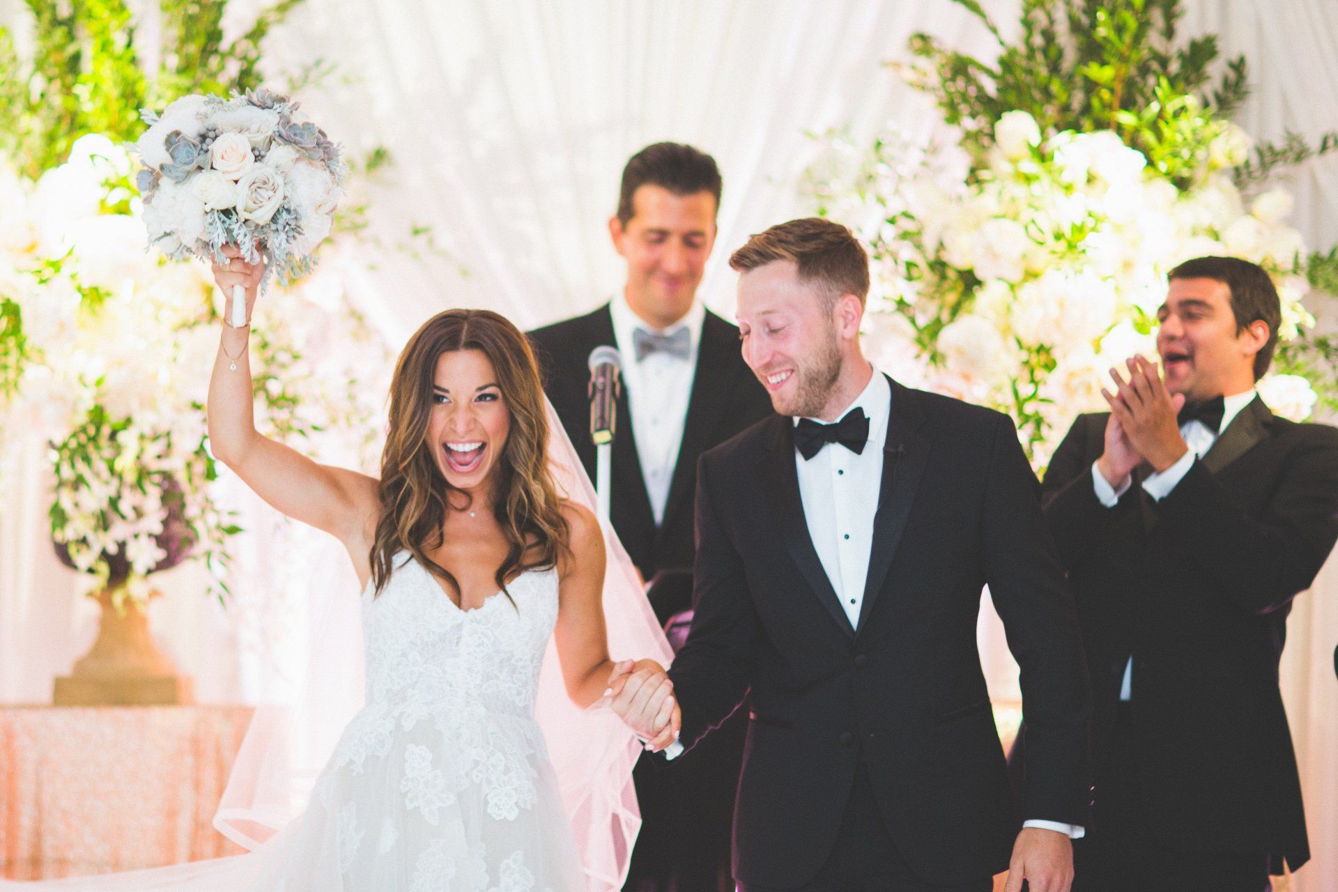 A bride and groom are walking down the aisle at their wedding ceremony.