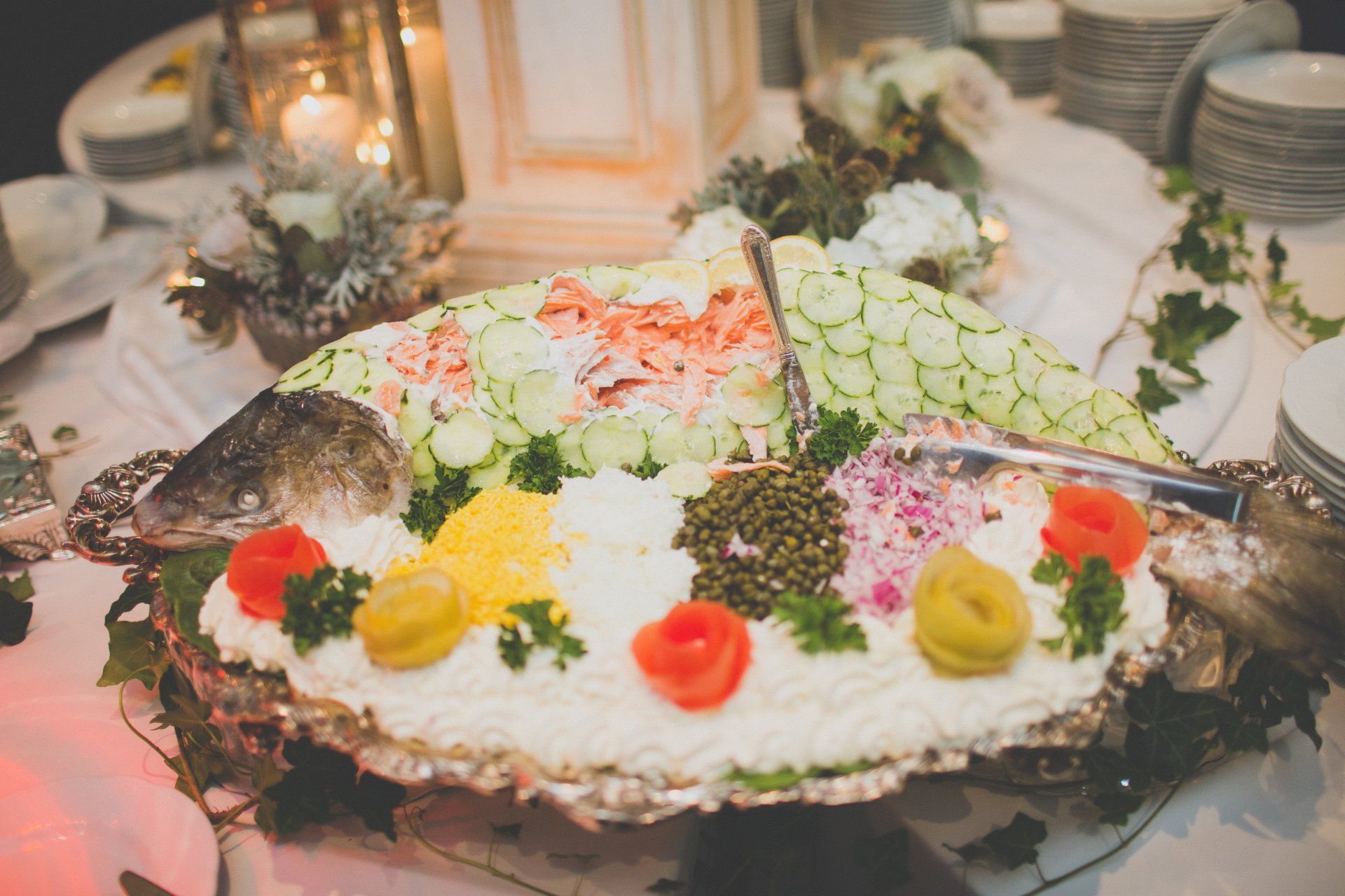 A plate of food on a table with a fish on top of it.