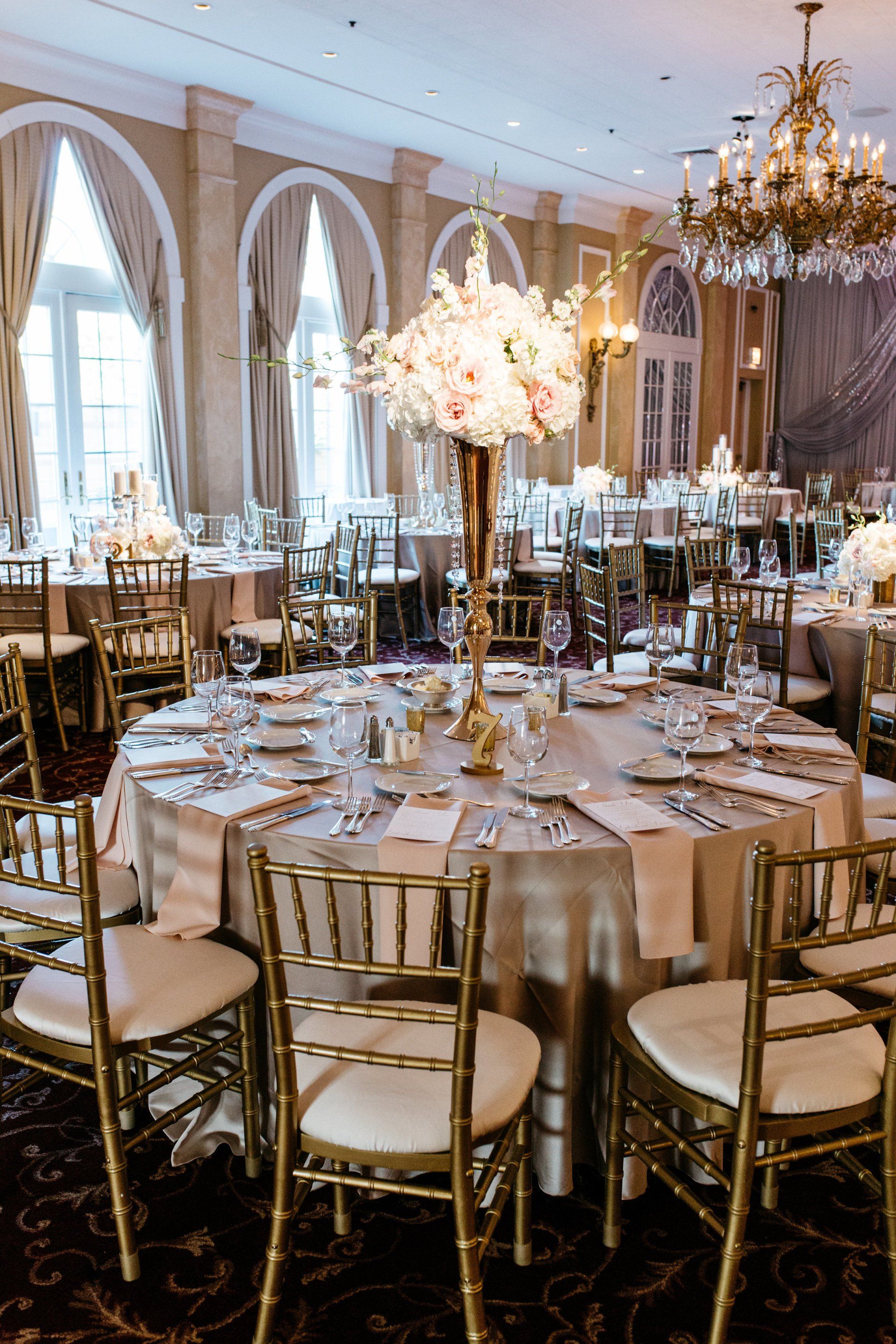 A large room with tables and chairs set up for a wedding reception.