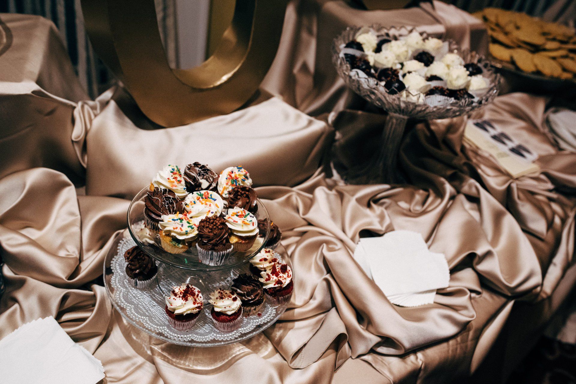 A table with cupcakes and cookies on it