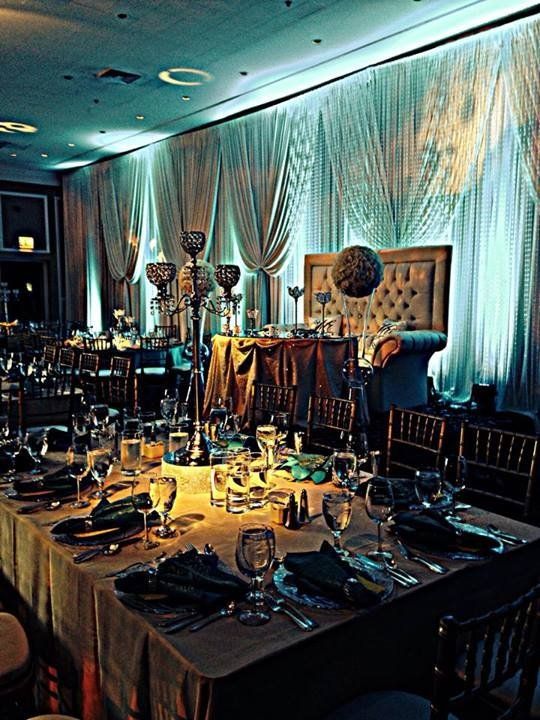 A large room with tables and chairs set up for a party