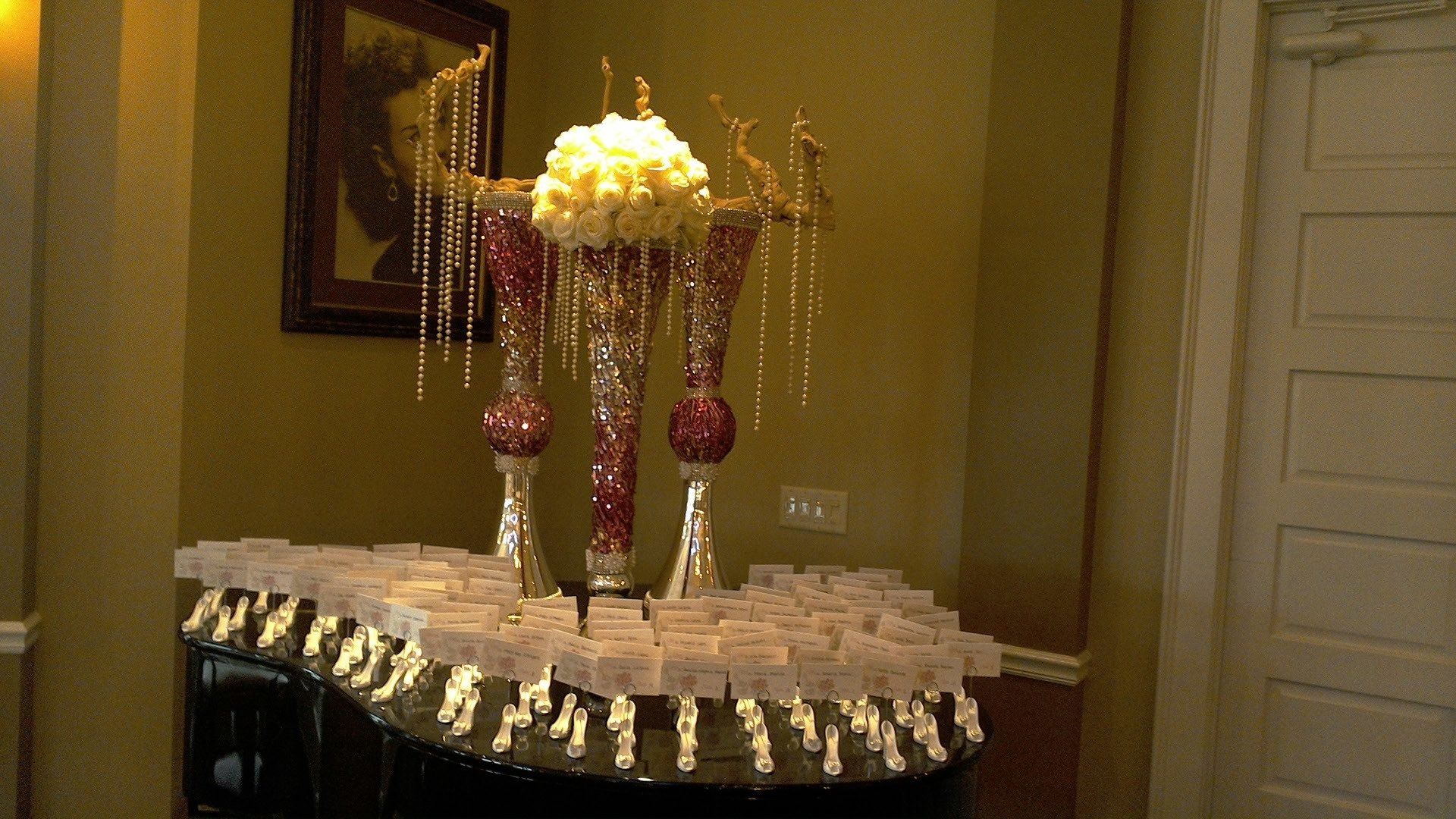 A table with a lot of candles and flowers on it