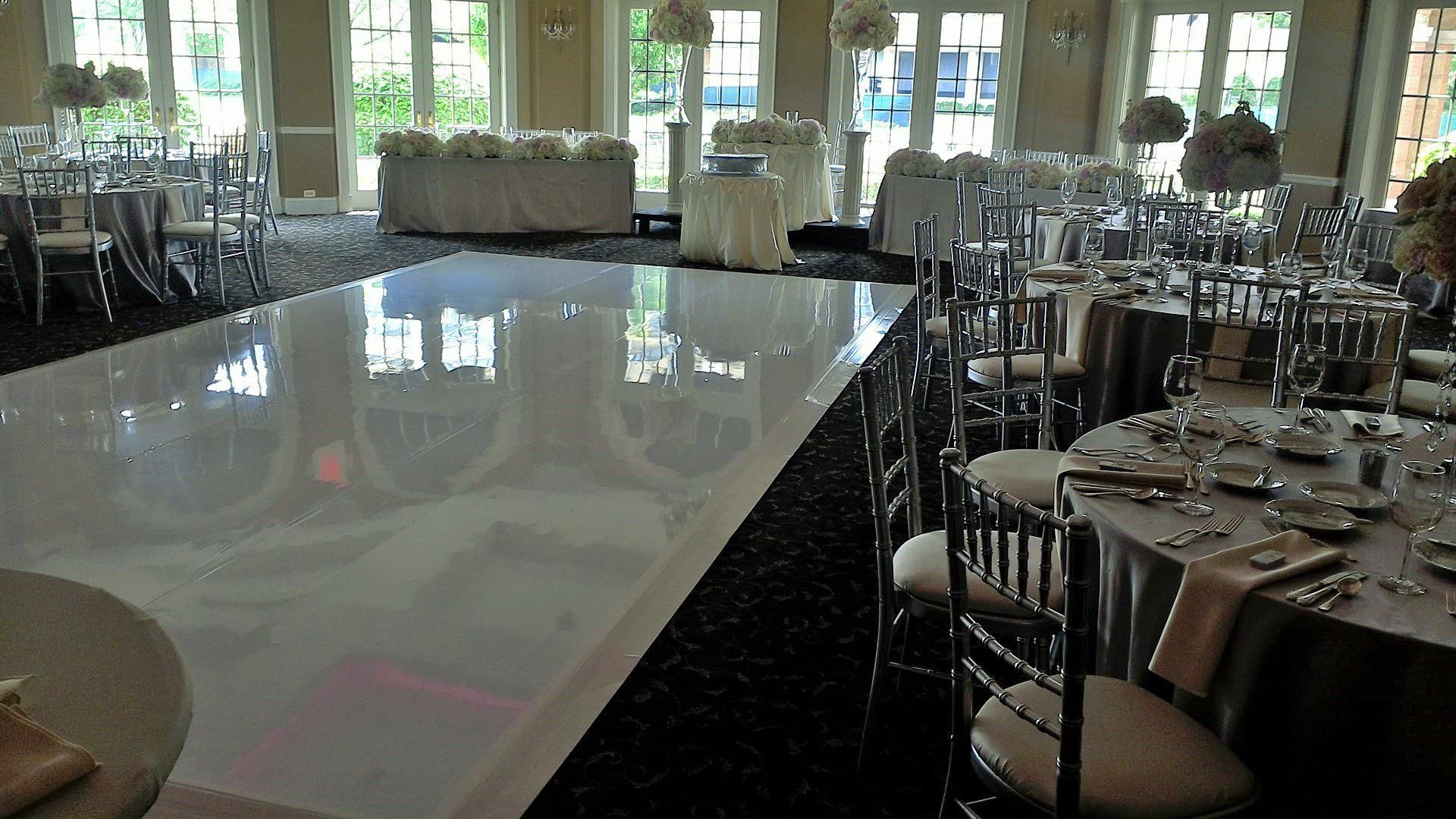 A large room with tables and chairs and a dance floor