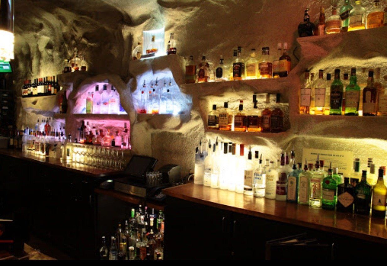 A bar filled with lots of bottles of alcohol