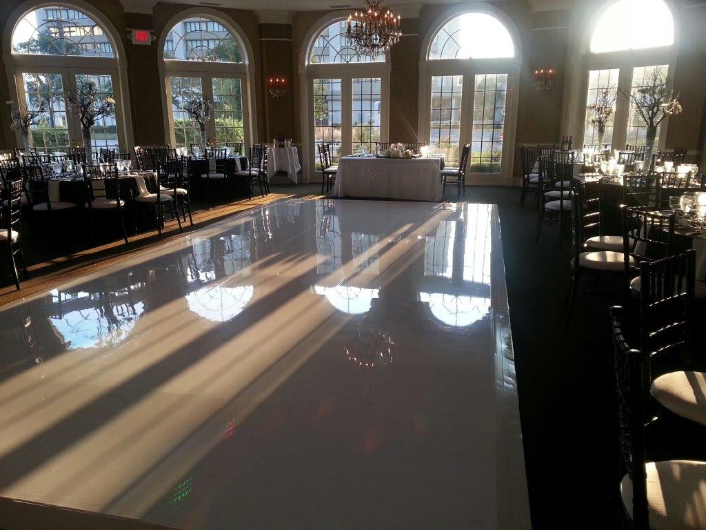 A large room with tables and chairs and a dance floor