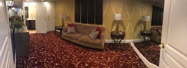 A living room with a couch and a red carpet