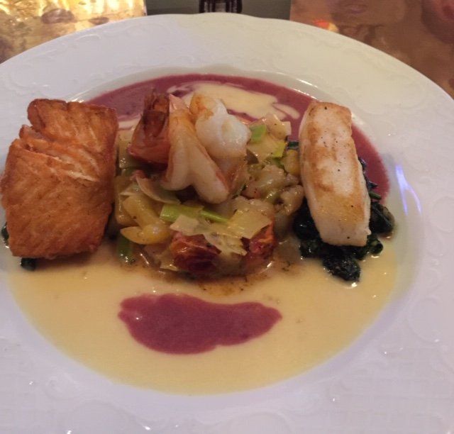 A plate of food with a purple sauce on it