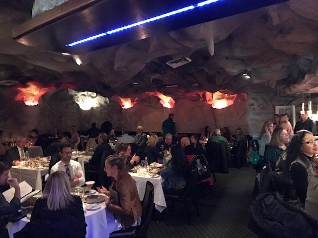 A group of people are sitting at tables in a restaurant