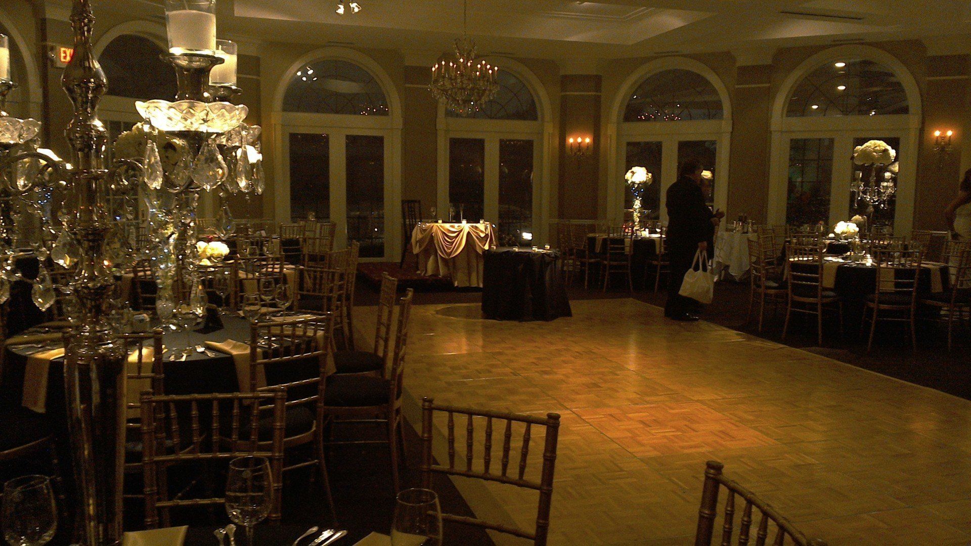 A large room with tables and chairs and a dance floor