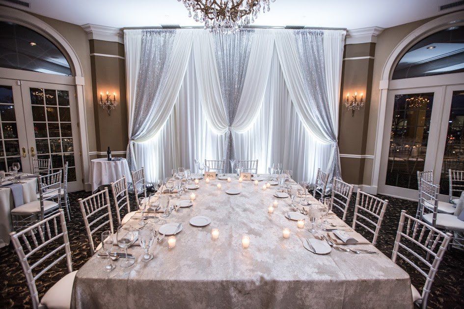 A long table with candles on it in a room.