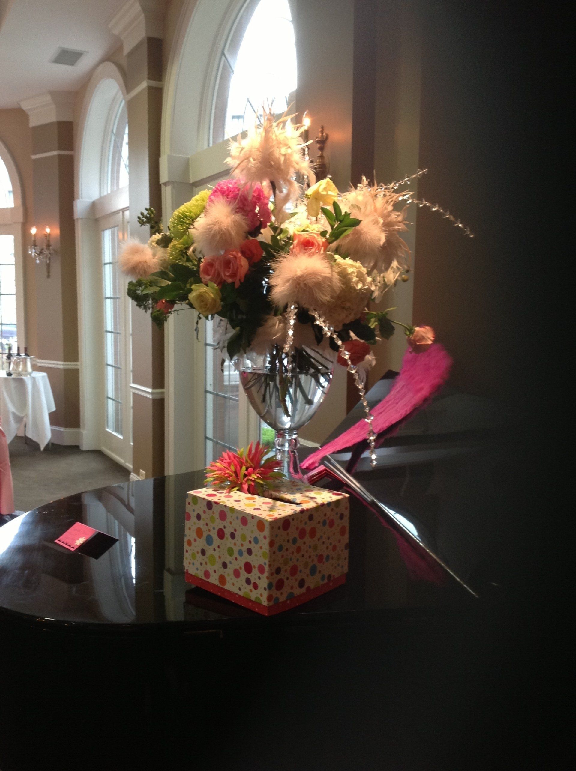 A vase filled with flowers sits on a table in a room.