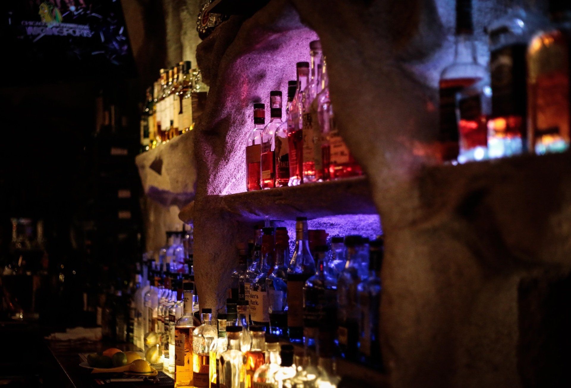 A bar filled with lots of bottles of alcohol.