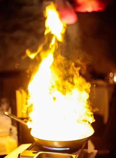 A frying pan with flames coming out of it