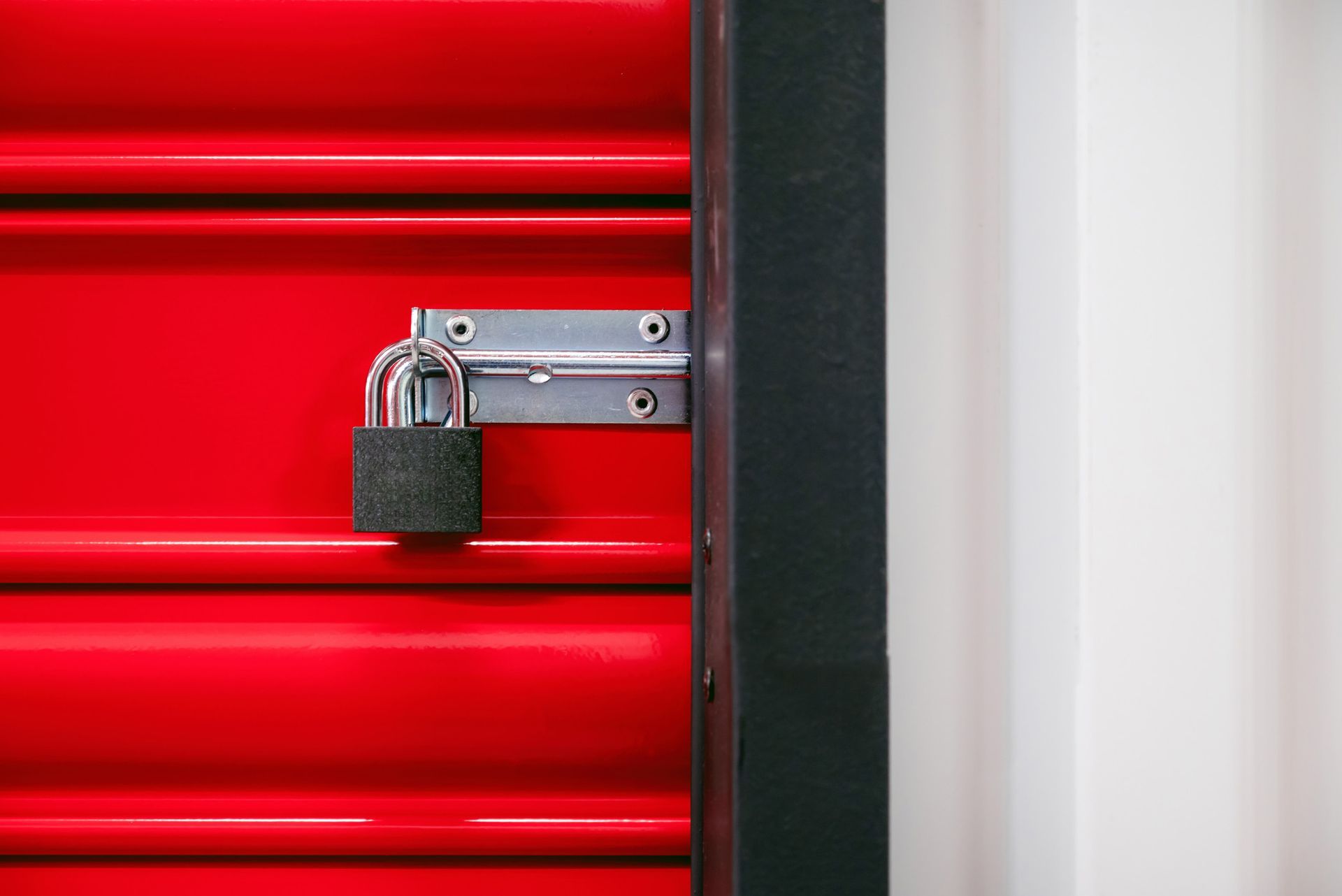 A red door with a padlock on it.