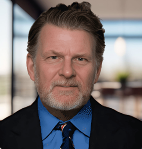 A man, head attorney Robert Byrnes, with a beard is wearing a suit and tie.