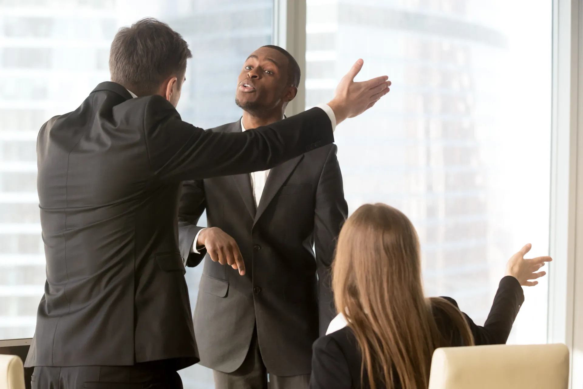 A group of business people are arguing in an office.