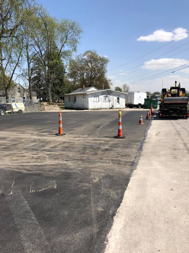 Warehouse Installing Asphalt Using Excavator — Northwood, OH — D & D Paving Inc.