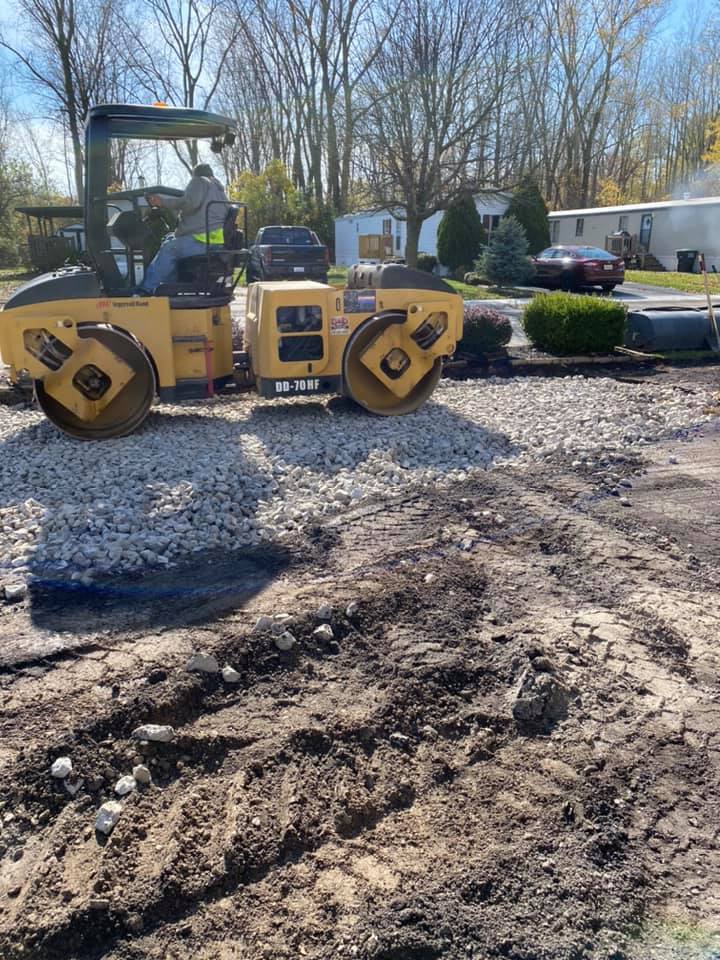 Man Working with Excavator — Northwood, OH — D & D Paving Inc.