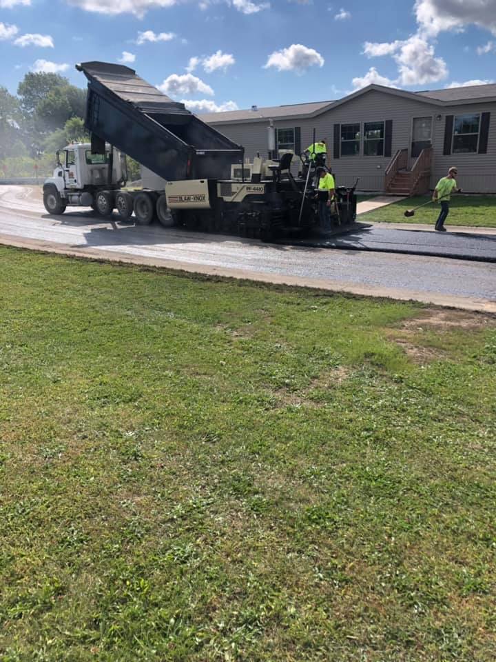 Men Works in Front of A House — Northwood, OH — D & D Paving Inc.