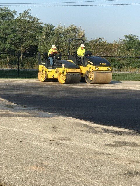Two Men Works Using Excavator — Northwood, OH — D & D Paving Inc.