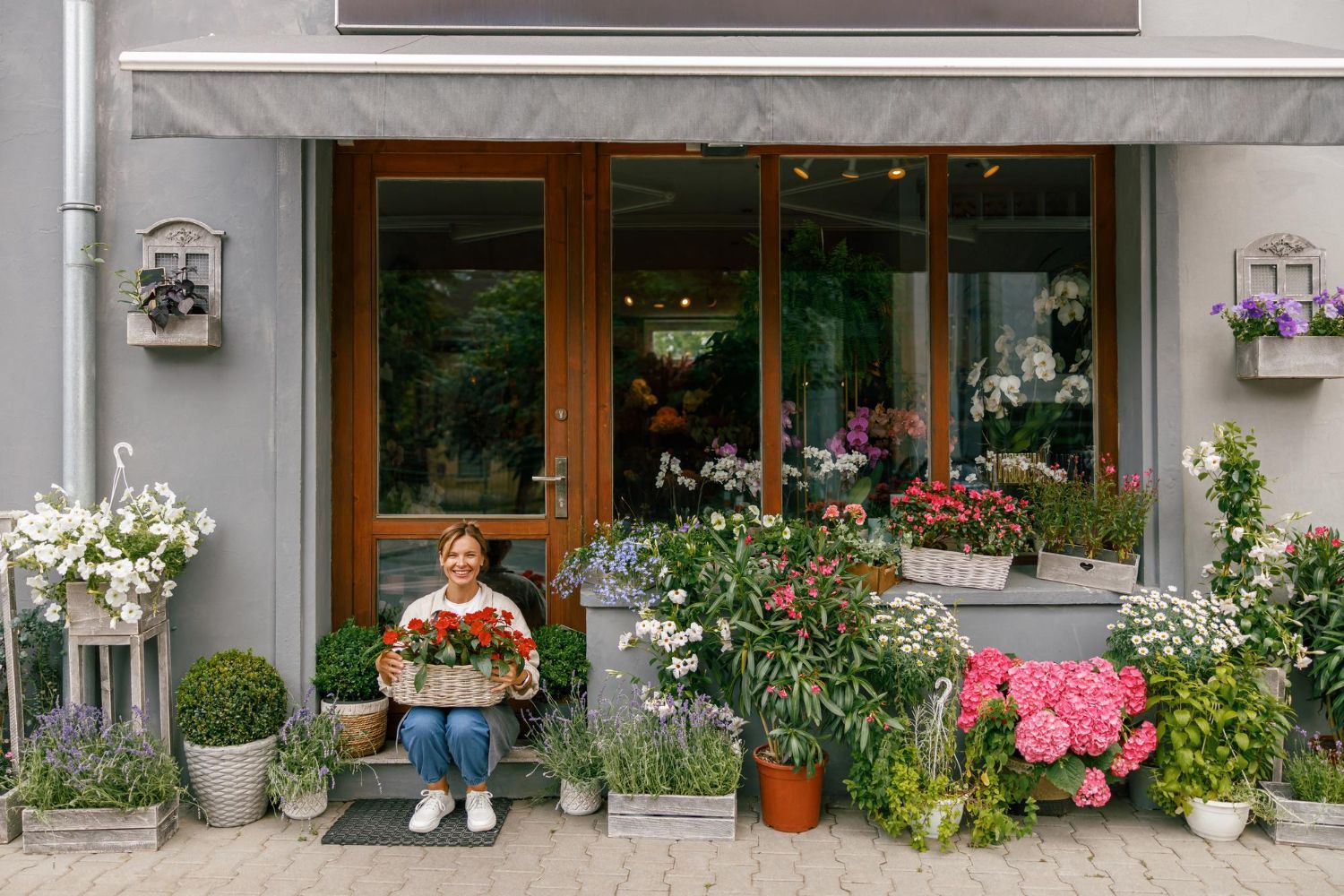 A woman is walking down the street holding a cup of coffee.