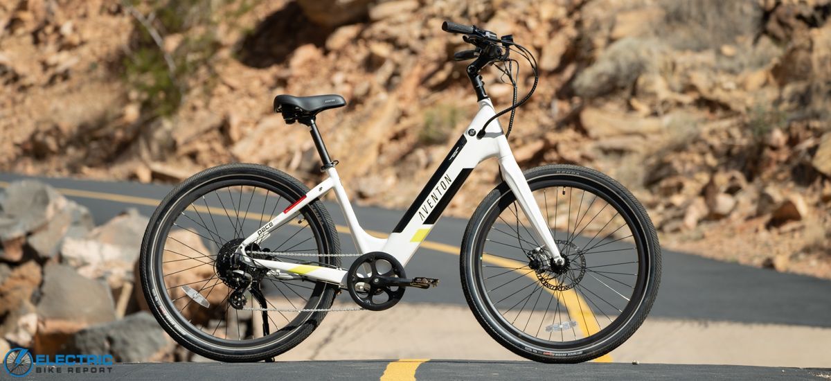 A row of electric bikes are parked next to each other.