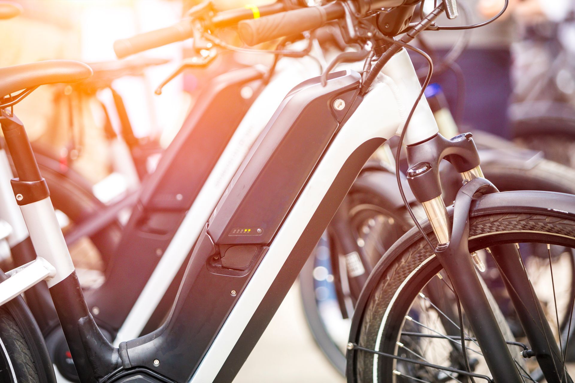 A row of electric bikes are parked next to each other.
