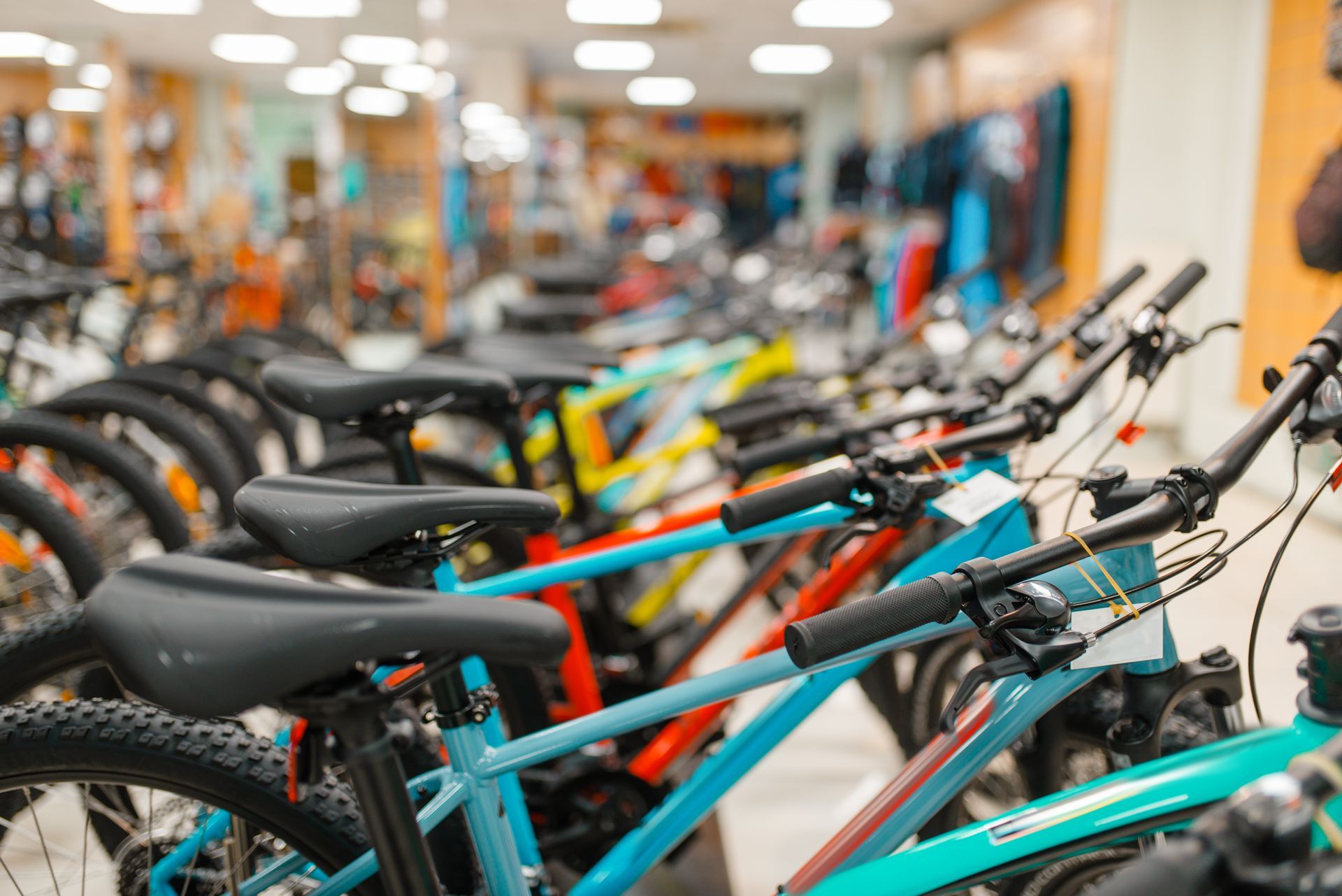 A row of bicycles are lined up in a store.