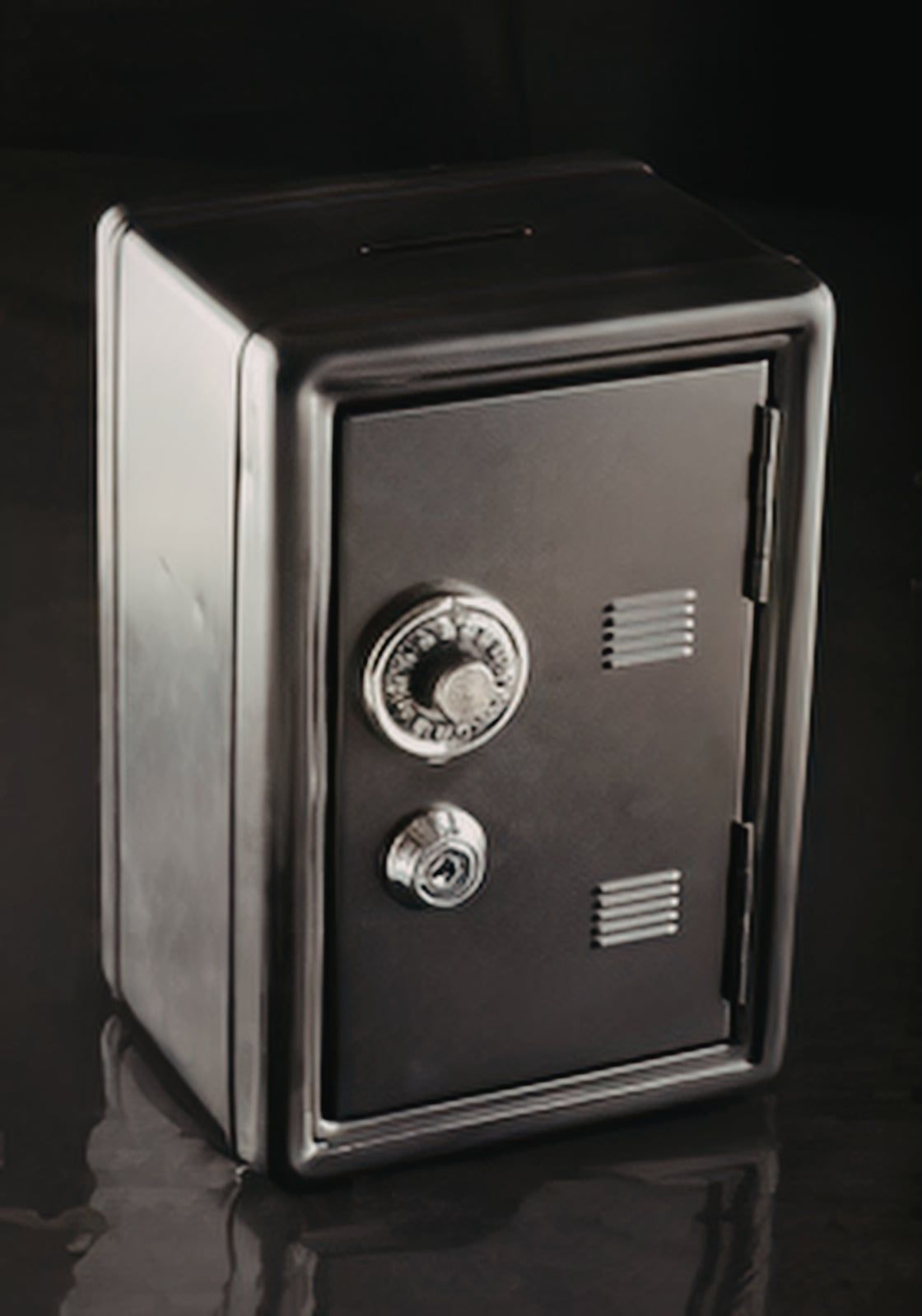Small black metal safe with a dial and handle, shown against a dark background.