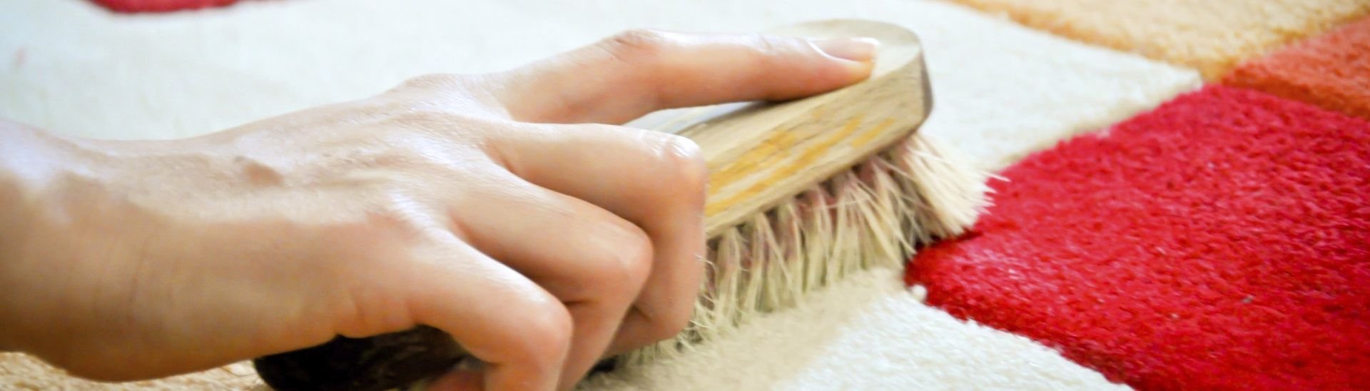A woman cleaning a carpet