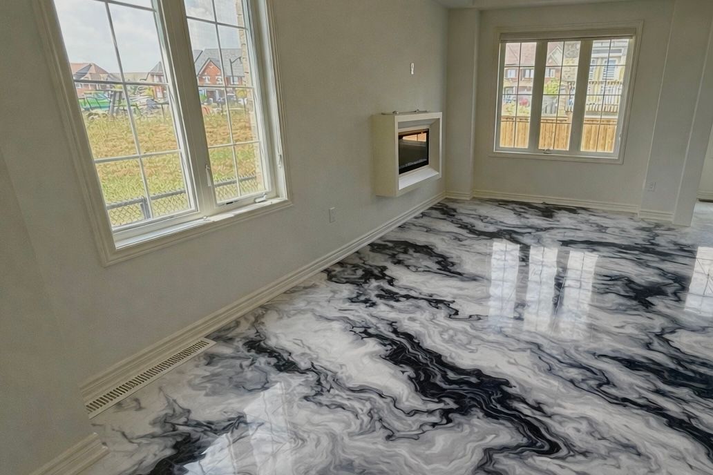 A room with white walls, two windows, a fireplace, and a high-gloss, black-and-white marbled epoxy floor.