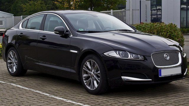 A black jaguar is parked in a parking lot