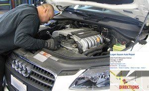 A man is working on the engine of a car.