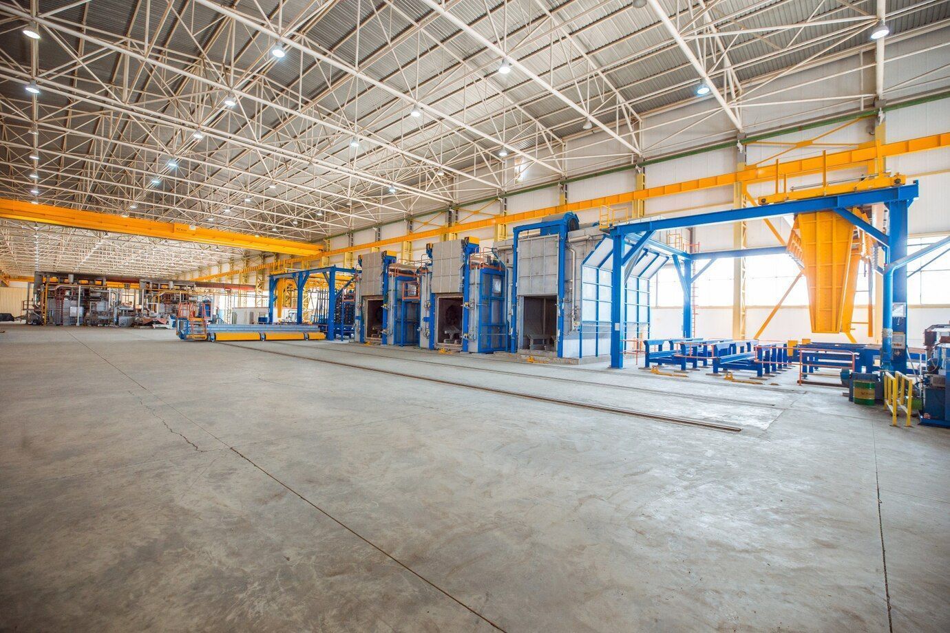 A large warehouse with a lot of machinery in it.