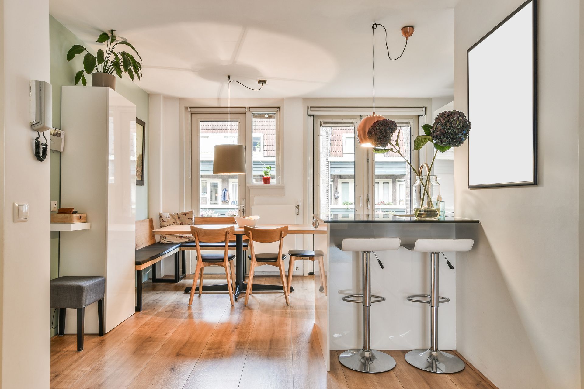 A kitchen and dining room with a table and chairs