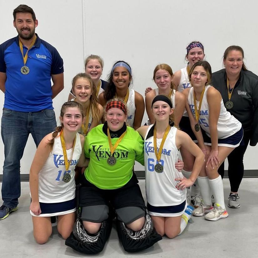 A group of female athletes posing for a picture with medals around their necks.