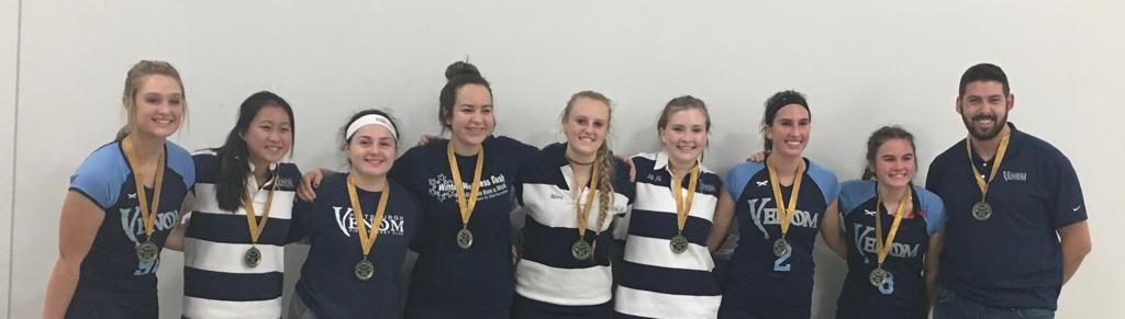 A group of people standing next to each other with medals around their necks.