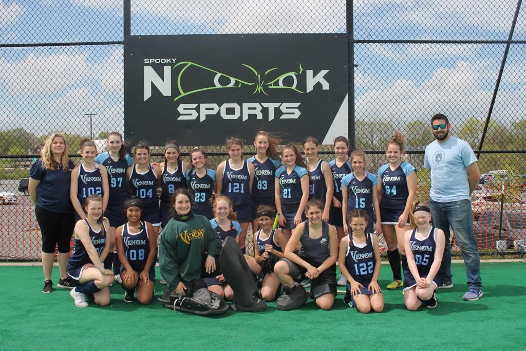 A group of people posing for a picture in front of a sign that says nc kayak sports