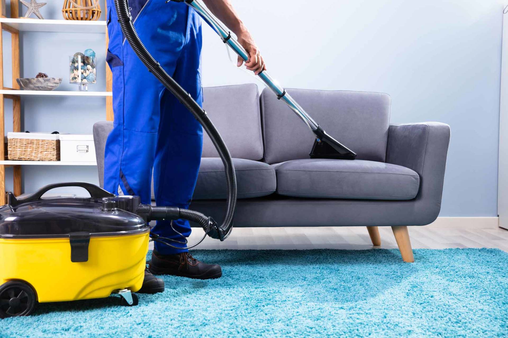 Man Cleaning Sofa With Vacuum Cleaner — Middletown, NY — Right Source Cleaning Service LLC